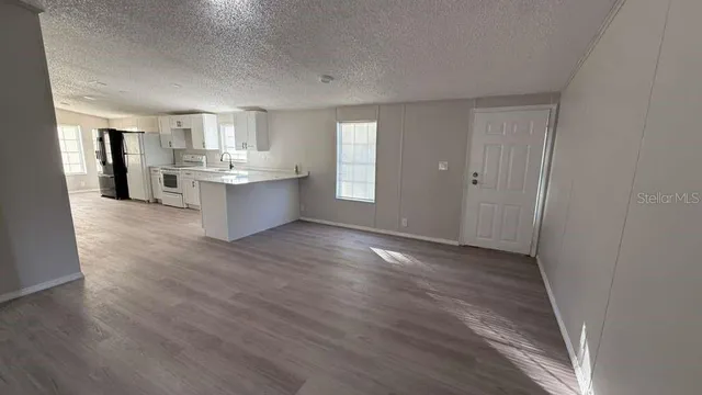 a view of kitchen and wooden floor