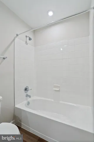 a bathroom with a bathtub and a toilet