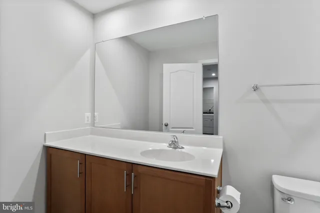a bathroom with a sink toilet and vanity