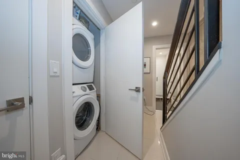 a view of a hallway with washer and dryer