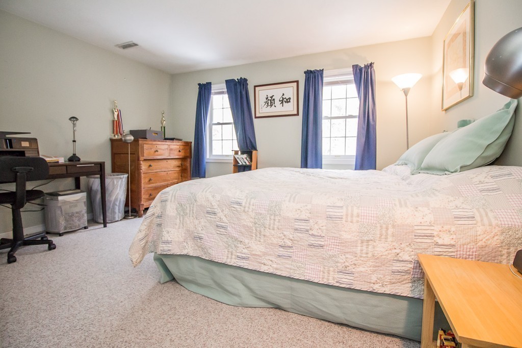 260 Manchaug Road Sutton, MA 01590 - Photo 23 of 29 a bedroom with a bed a large window and dresser
