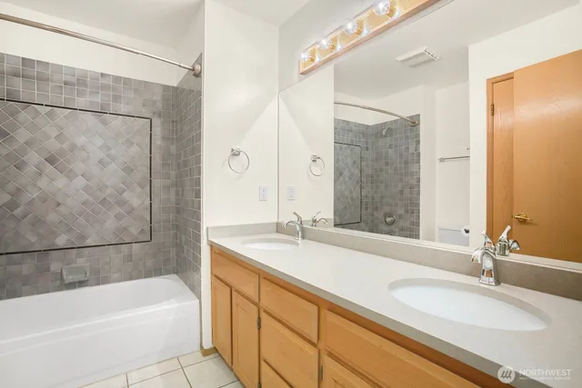 a bathroom with a granite countertop tub sink and a mirror