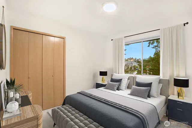 a bedroom with a bed and a window