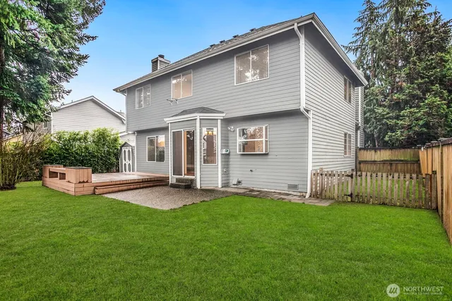a view of a house with a yard and deck