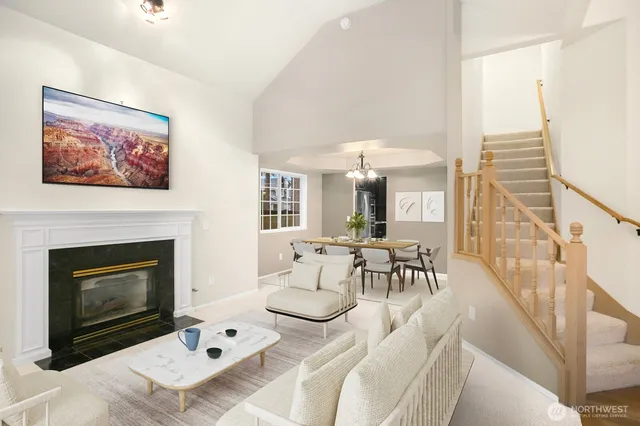 a living room with furniture a fireplace and a table