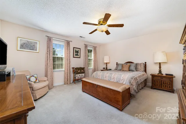 a spacious bedroom with a bed and furniture