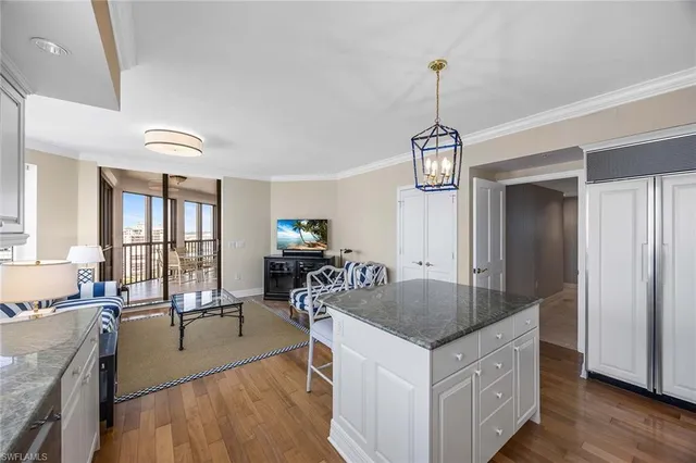 a kitchen with center island a sink appliances and a dining table