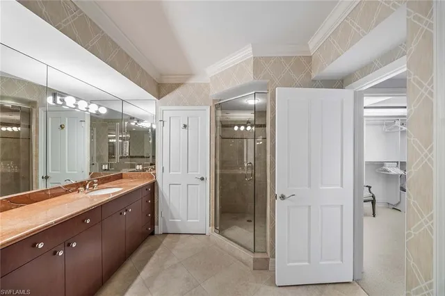 a bathroom with a double vanity sink mirror and shower