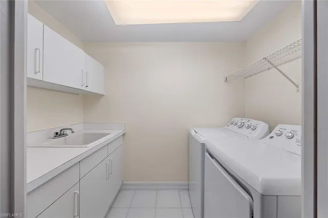 a utility room with a sink washer and dryer