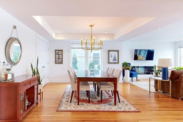 a living room with furniture a fireplace and a chandelier