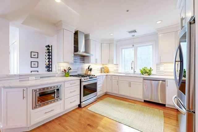 a kitchen with a stove top oven sink and cabinets