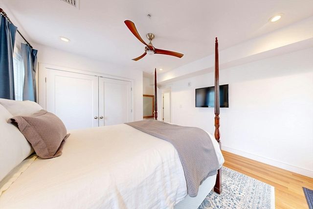 a bedroom with a bed and a night stand