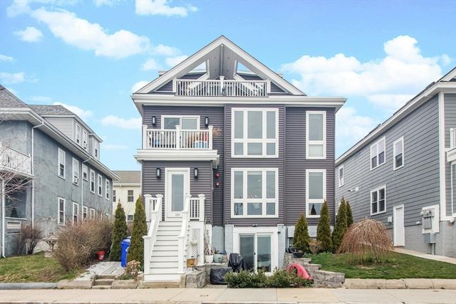 a front view of a residential apartment building with a yard