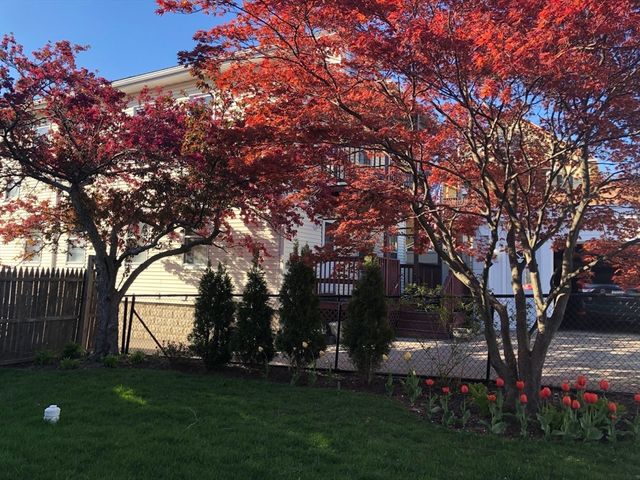 a backyard of a house with lots of green space and garden