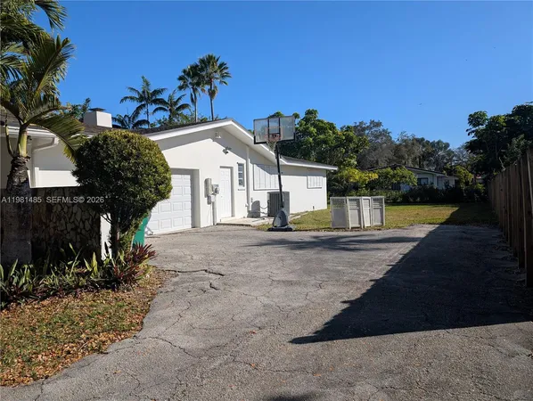 a view of a house with pool and sitting area