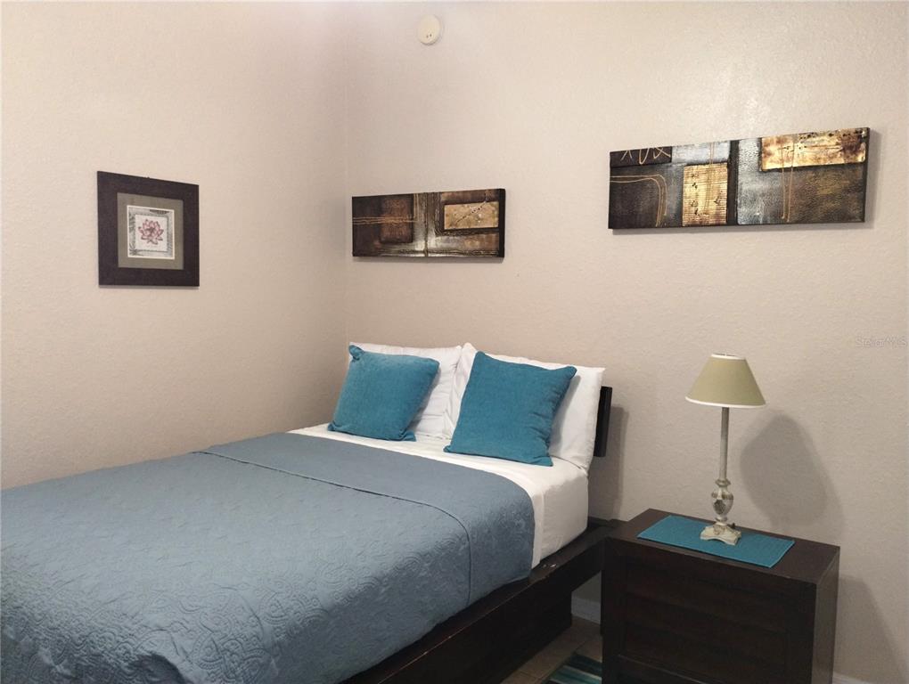 219 Cloverdale Road Winter Haven, FL 33884 - Photo 15 of 19 a bedroom with a bed and two lamp on desk