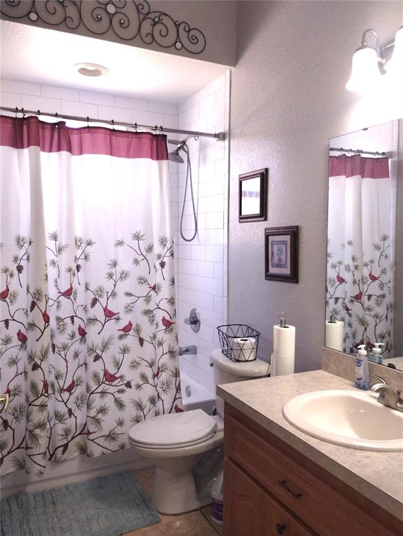 219 Cloverdale Road Winter Haven, FL 33884 - Photo 16 of 19 a bathroom with a sink a toilet and shower curtain