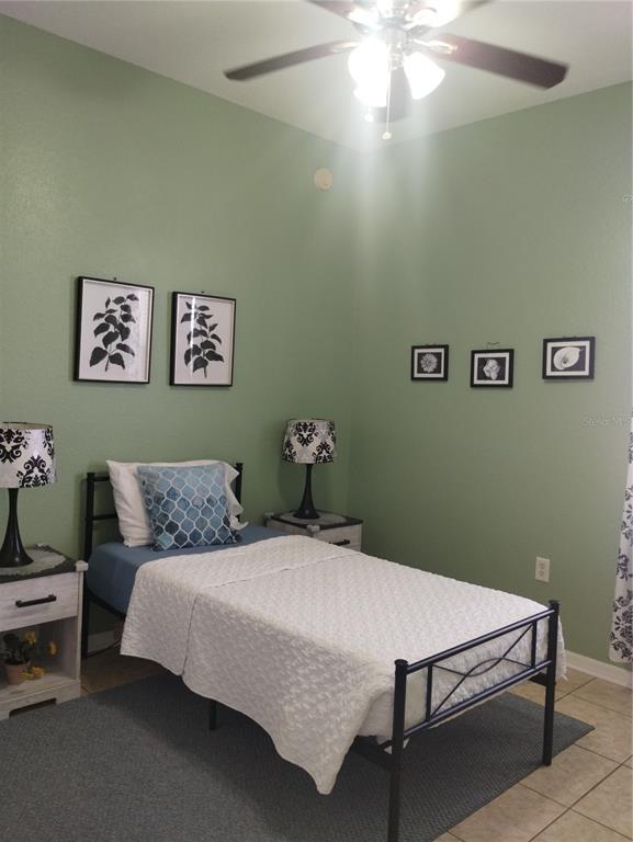 219 Cloverdale Road Winter Haven, FL 33884 - Photo 18 of 19 a bedroom with a bed and a chandelier