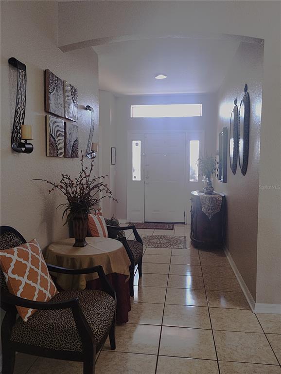 219 Cloverdale Road Winter Haven, FL 33884 - Photo 2 of 19 a living room with furniture and a potted plant