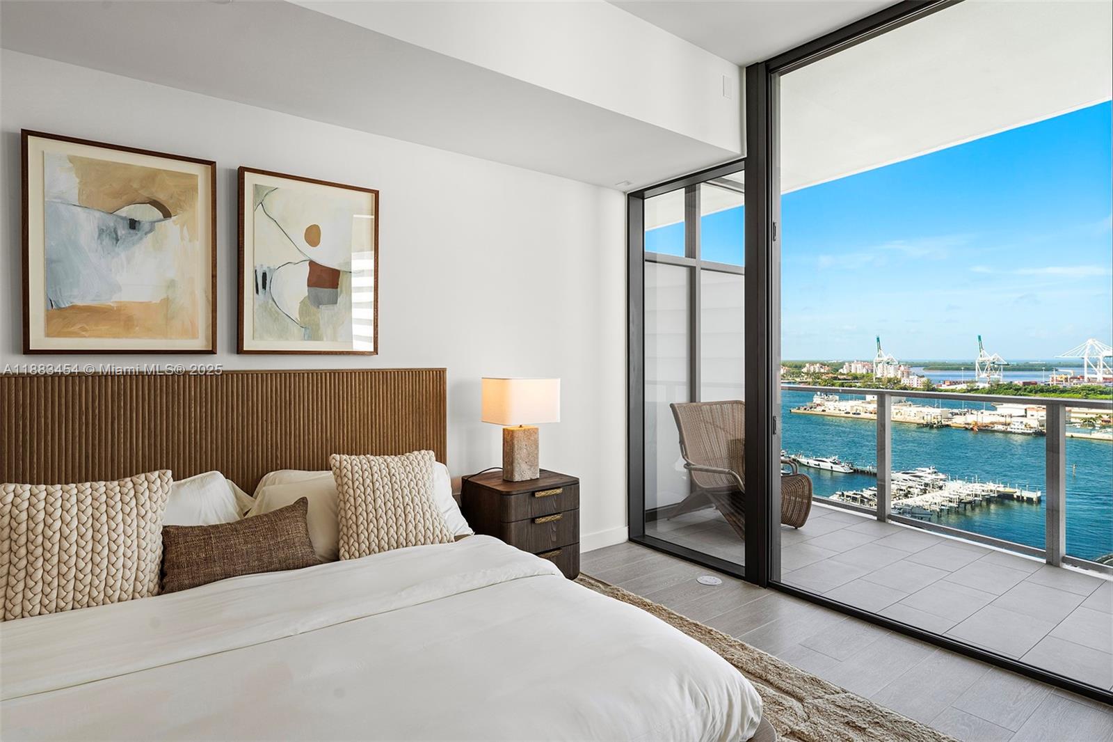 500 Alton Road, Unit 1904 Miami Beach, FL 33139 - Photo 13 of 31 a bedroom with a bed and glass window