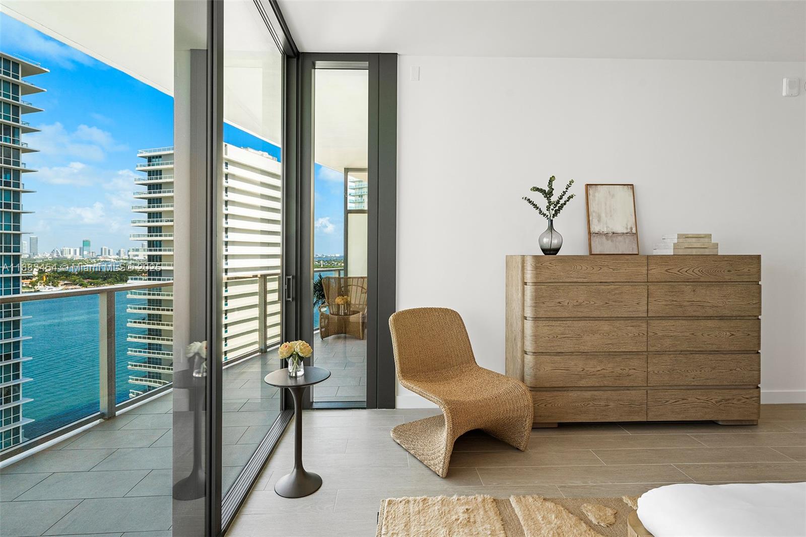500 Alton Road, Unit 1904 Miami Beach, FL 33139 - Photo 15 of 31 a bedroom with a bed and a chair