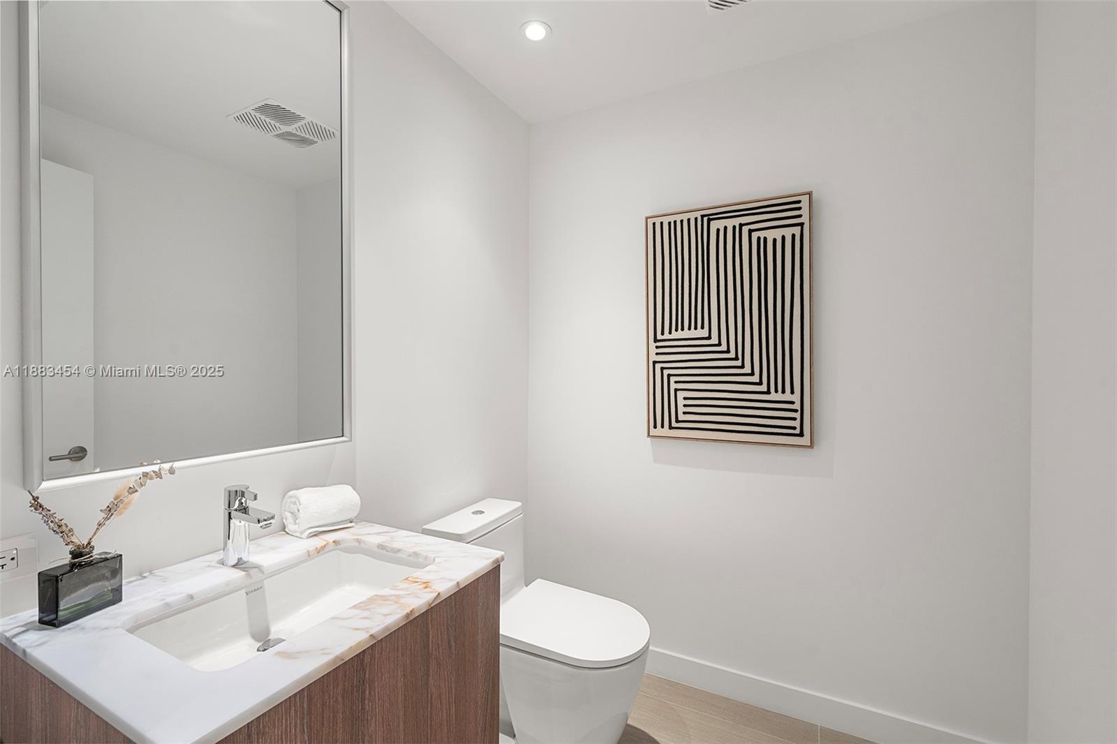 500 Alton Road, Unit 1904 Miami Beach, FL 33139 - Photo 23 of 31 a bathroom with a sink a toilet and mirror