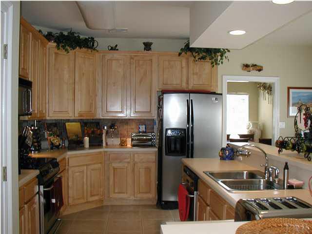 2575 Pine Forest Road Cantonment, FL 32533 - Photo 9 of 24 Kitchen has lovely maple cabinetry (notice the great backsplash, as well!)