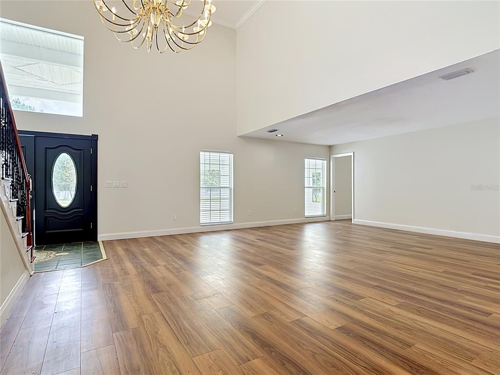 7925 Lake Mabel Loop Road Lake Wales, FL 33898 - Photo 13 of 97 a view of an empty room with window and wooden floor