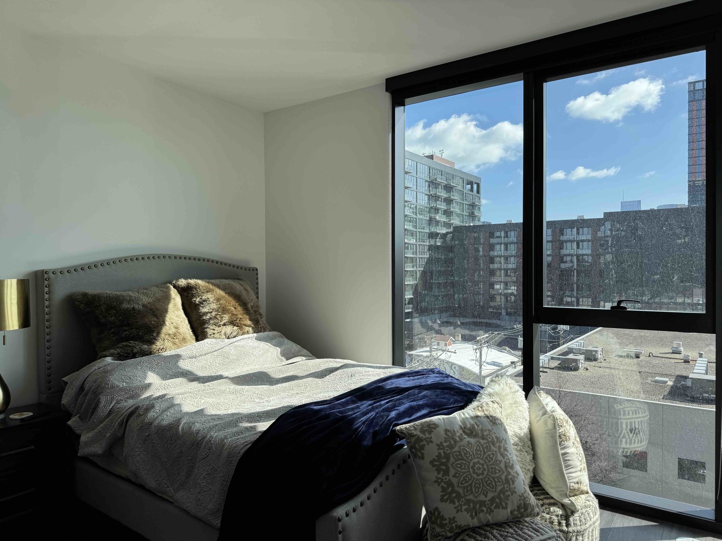Undisclosed Address Chicago, IL 60607 - Photo 12 of 28 a bedroom with a bed and glass door