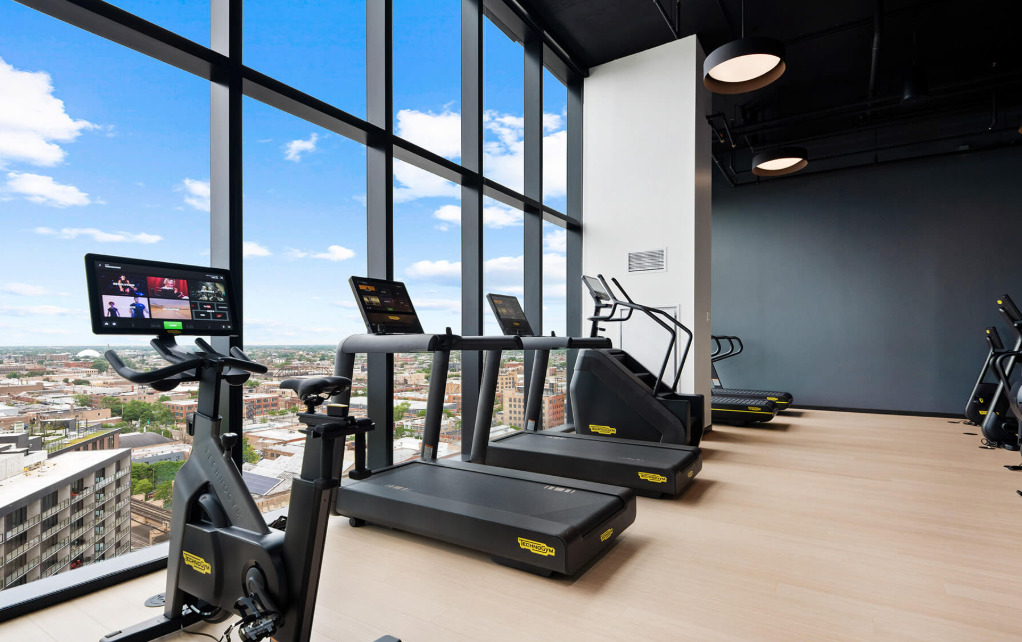 Undisclosed Address Chicago, IL 60607 - Photo 21 of 28 a room with gym equipment and a large window
