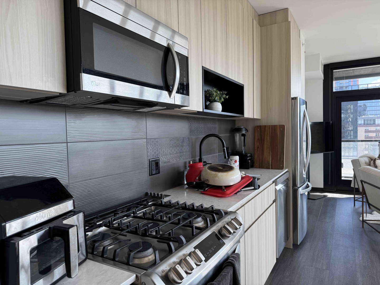 Undisclosed Address Chicago, IL 60607 - Photo 8 of 28 a kitchen with stainless steel appliances a stove and cabinets