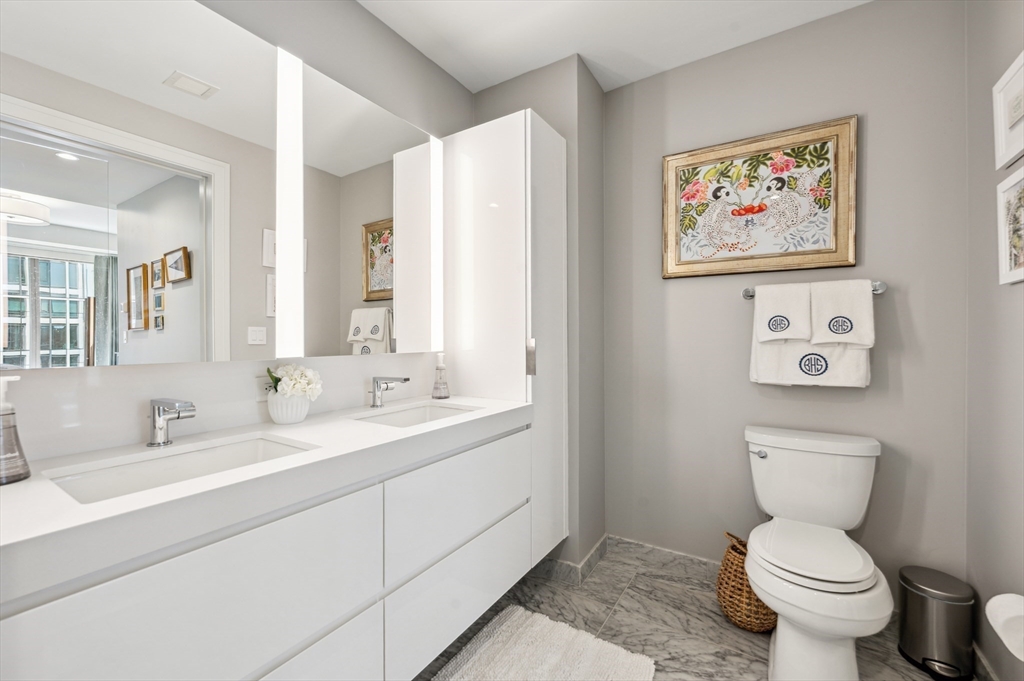 133 Seaport Boulevard, Unit 823 Boston, MA 02210 - Photo 13 of 31 a bathroom with a toilet sink and mirror