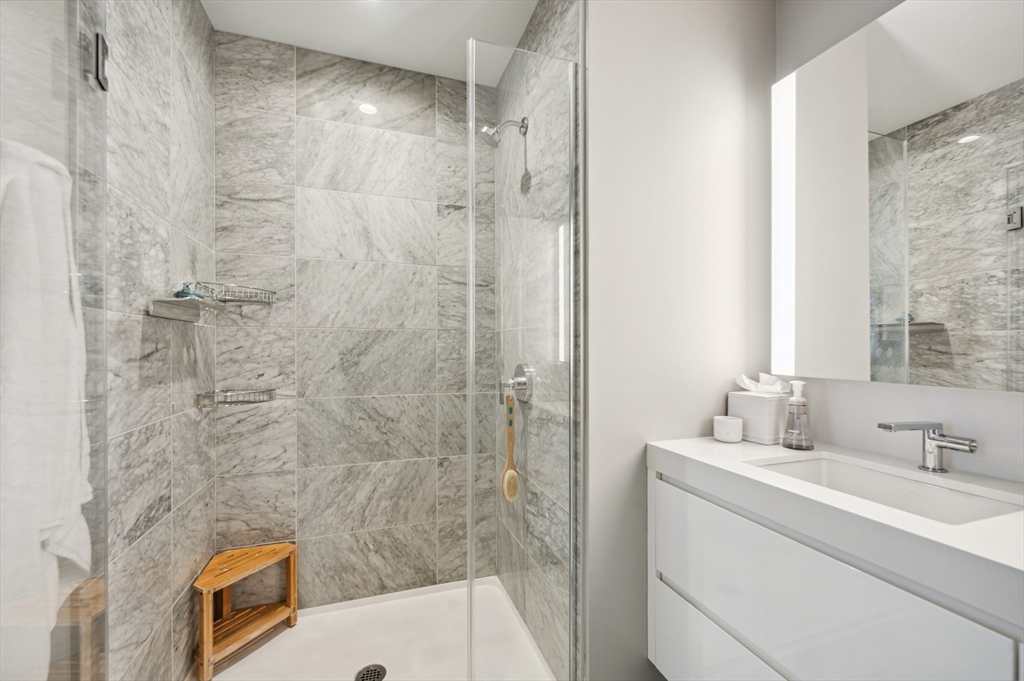 133 Seaport Boulevard, Unit 823 Boston, MA 02210 - Photo 14 of 31 a bathroom with a sink and a shower