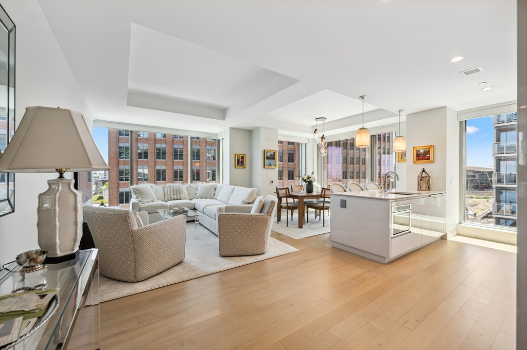 133 Seaport Boulevard, Unit 823 Boston, MA 02210 - Photo 2 of 31 a living room with furniture and a wooden floor