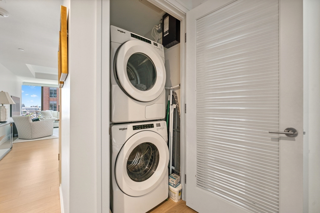 133 Seaport Boulevard, Unit 823 Boston, MA 02210 - Photo 21 of 31 a view of a hallway with washer and dryer