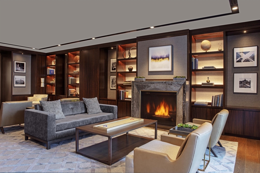 133 Seaport Boulevard, Unit 823 Boston, MA 02210 - Photo 29 of 31 a living room with furniture and a fireplace