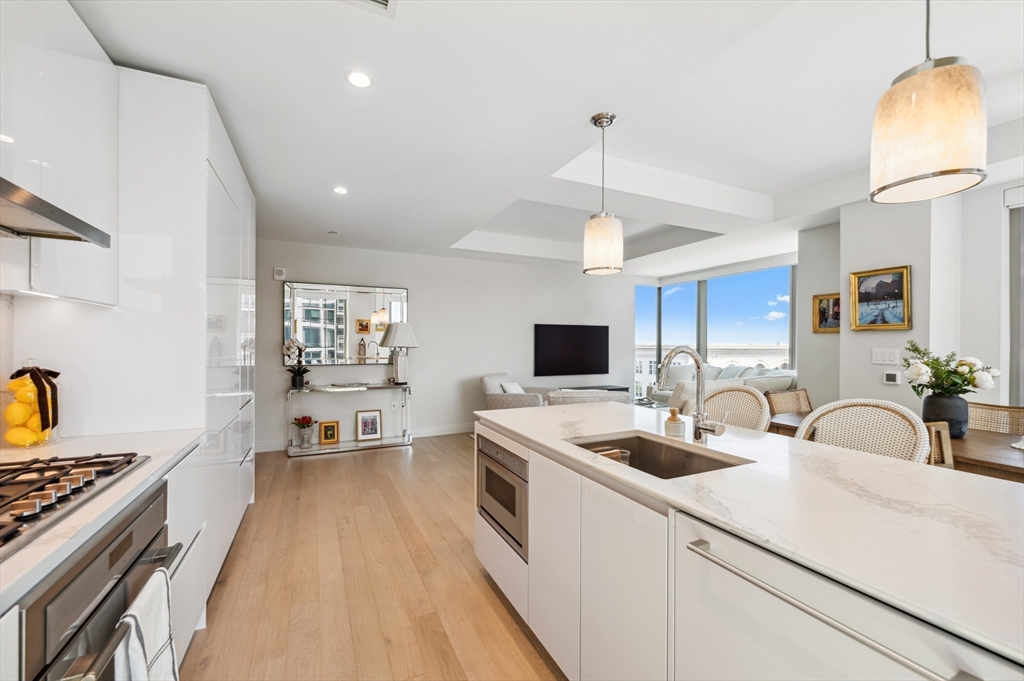 133 Seaport Boulevard, Unit 823 Boston, MA 02210 - Photo 7 of 31 a kitchen that has a sink and a stove in it