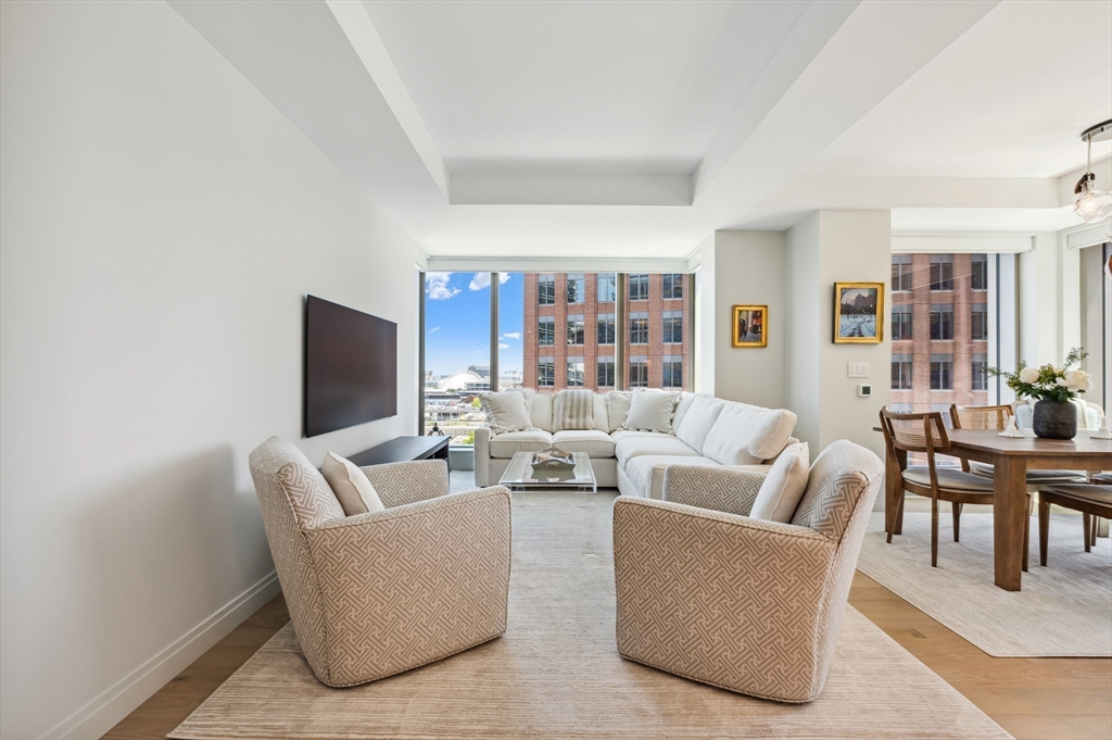 133 Seaport Boulevard, Unit 823 Boston, MA 02210 - Photo 9 of 31 a living room with furniture and a flat screen tv