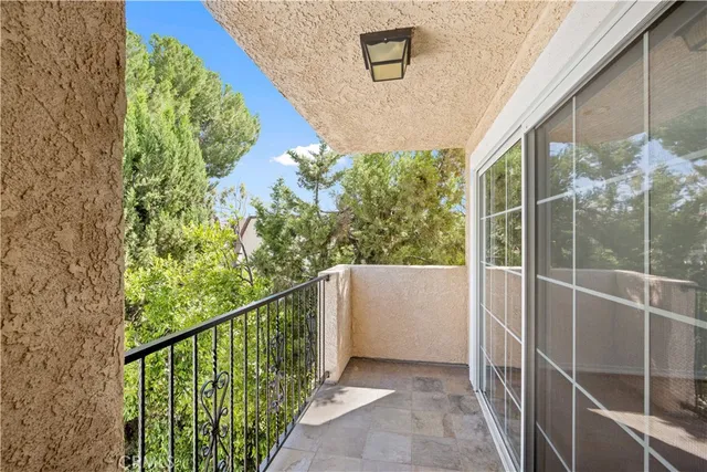 a balcony with view of outdoor space