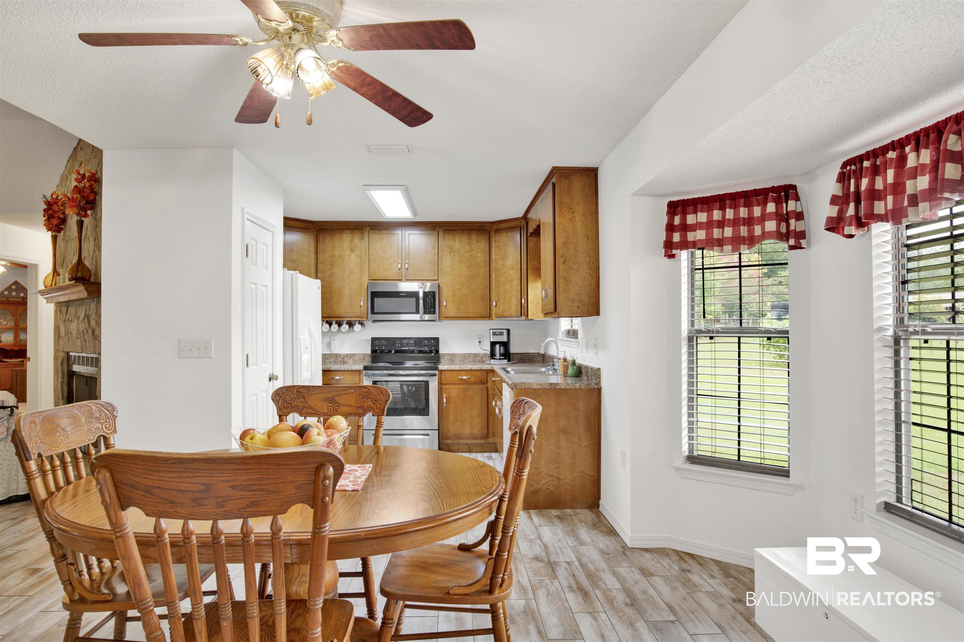 54563 Splinter Hill Road Perdido, AL 36562 - Photo 15 of 29 Dining area featuring ceiling fan, sink, a textured ceiling, and light hardwood / wood-style flooring