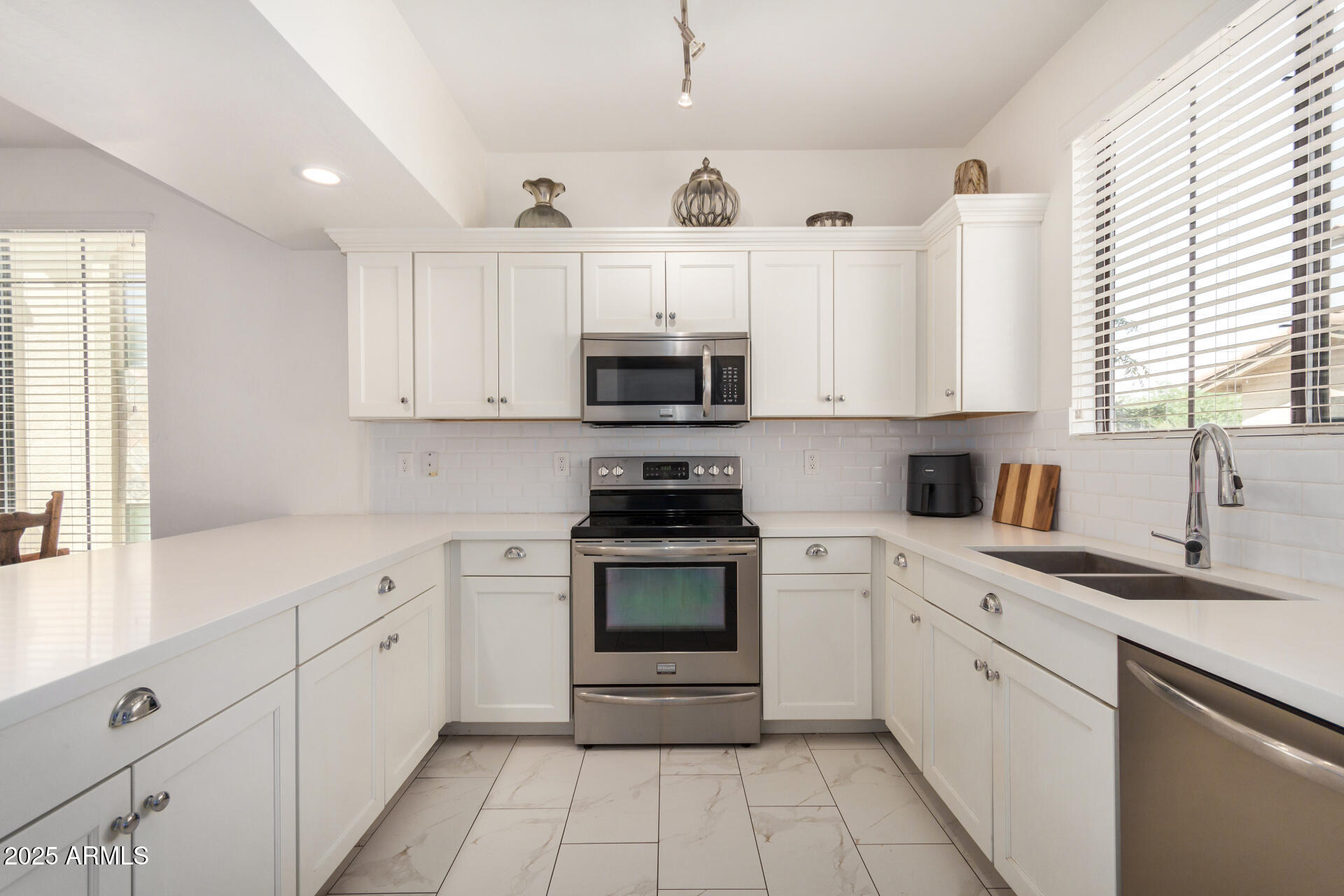 2315 North 52nd Street, Unit 144 Phoenix, AZ 85008 - Photo 2 of 28 a kitchen with cabinets appliances a sink and a window