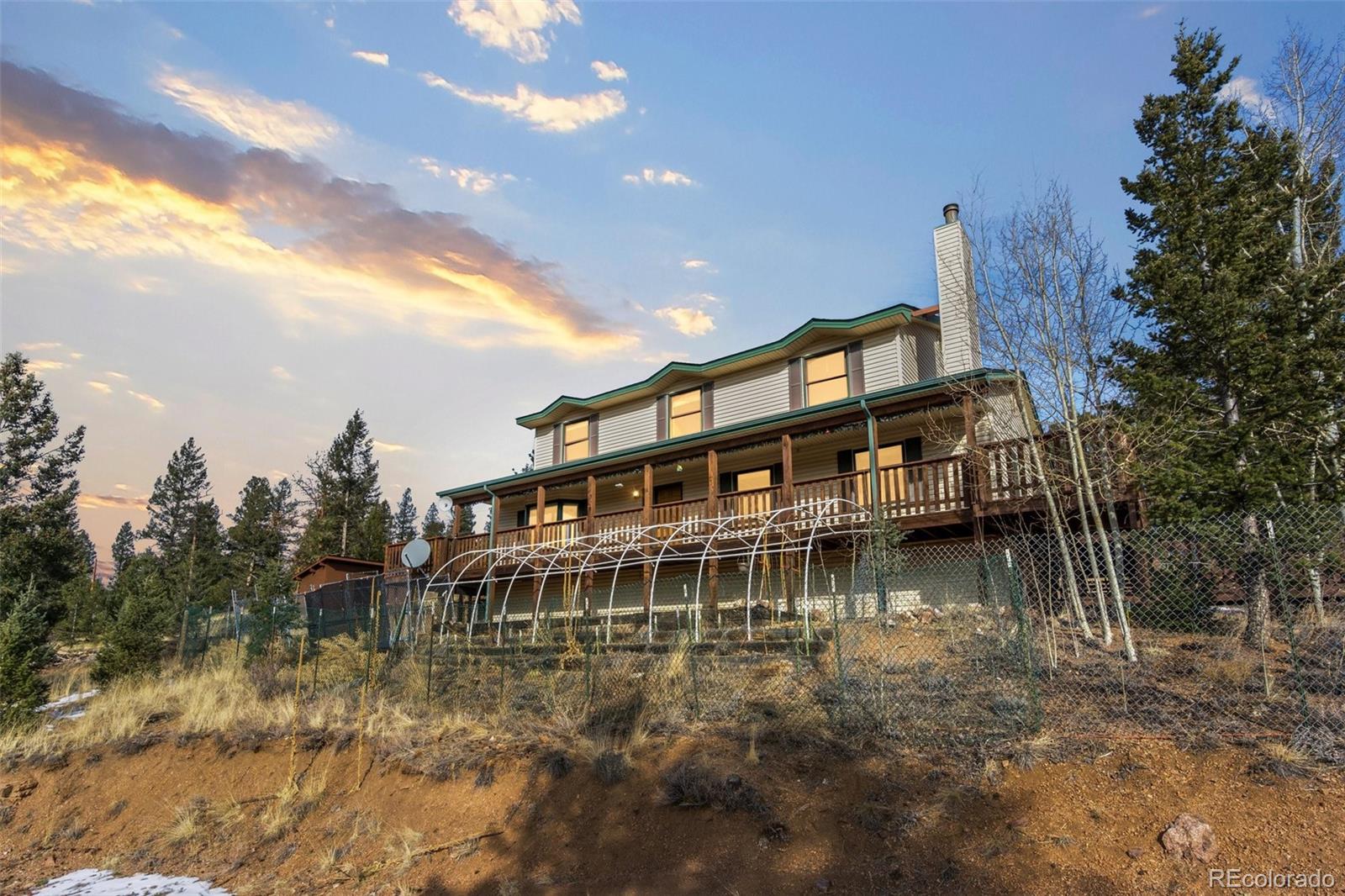 1602 Hitchrack Road Bailey, CO 80421 - Photo 2 of 4 a view of a large lake with a house in the background