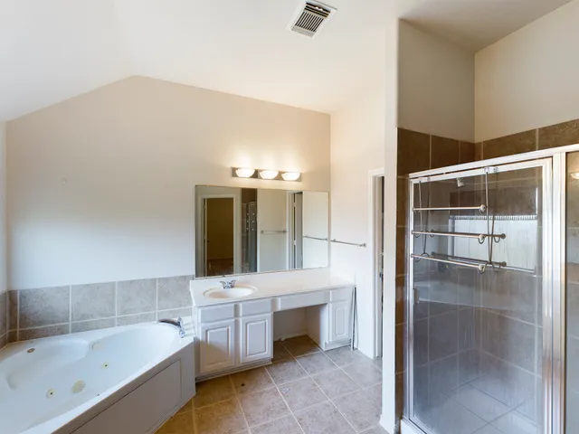 a bathroom with a bathtub and a sink