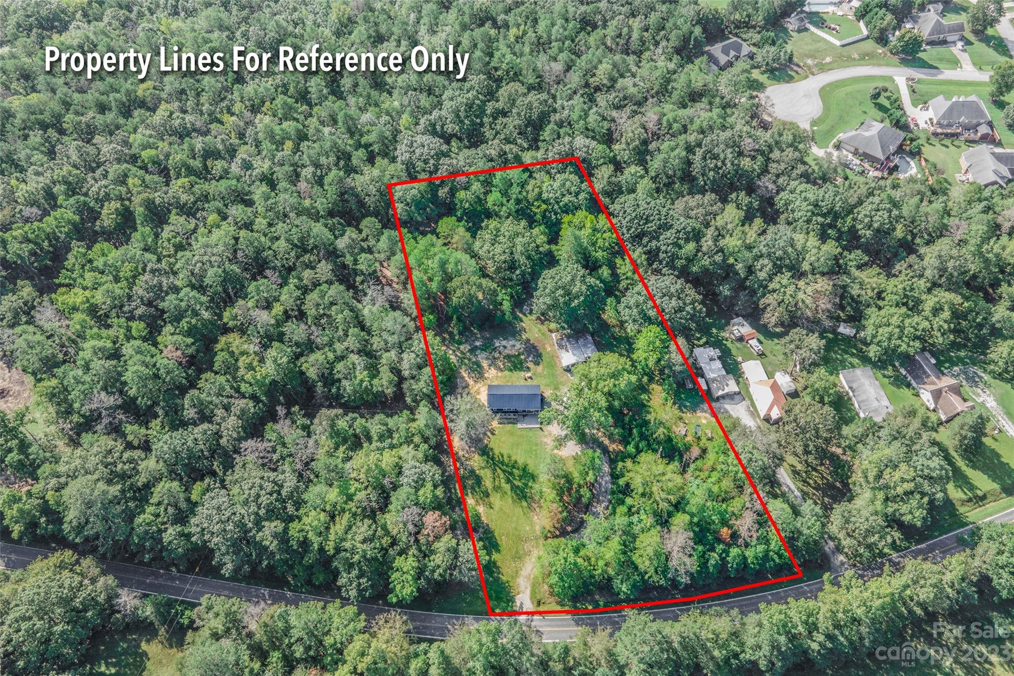 177 State Rd S-29-70 Lancaster, SC 29720 - Photo 3 of 30 an aerial view of a house with swimming pool and red chairs