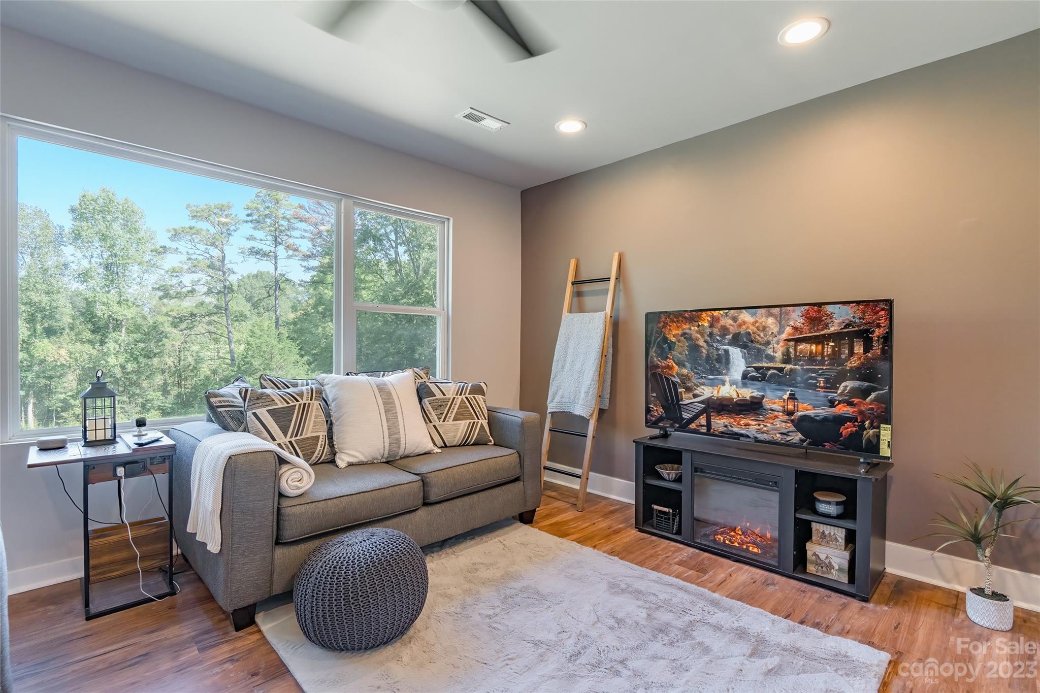 177 State Rd S-29-70 Lancaster, SC 29720 - Photo 8 of 30 a living room with furniture a large window and a flat screen tv