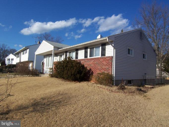 8830 Sigrid Road Randallstown, MD 21133 - Photo 3 of 19 a front view of a house with a yard