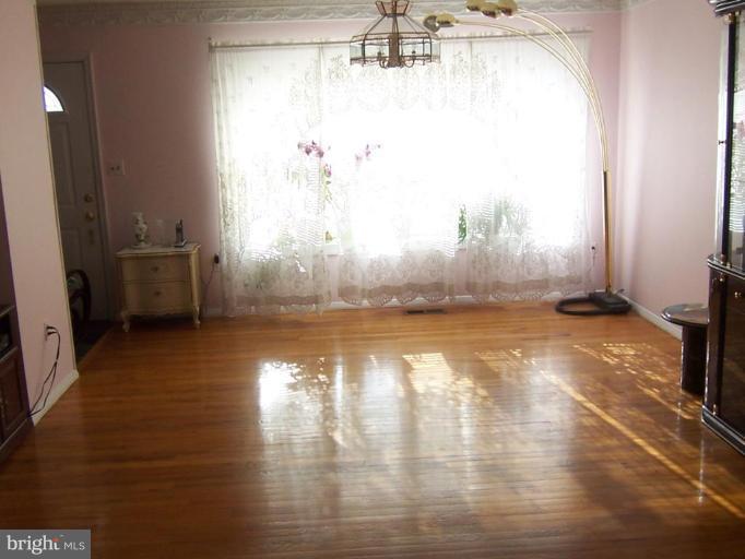 8830 Sigrid Road Randallstown, MD 21133 - Photo 8 of 19 a view of a room with window and wooden floor