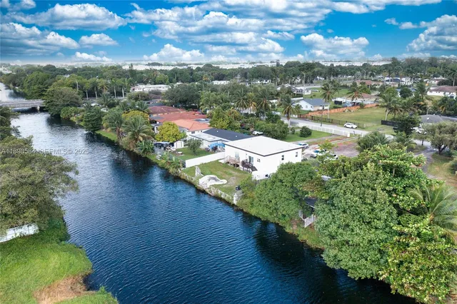 an aerial view of a house with a yard basket ball court and outdoor seating