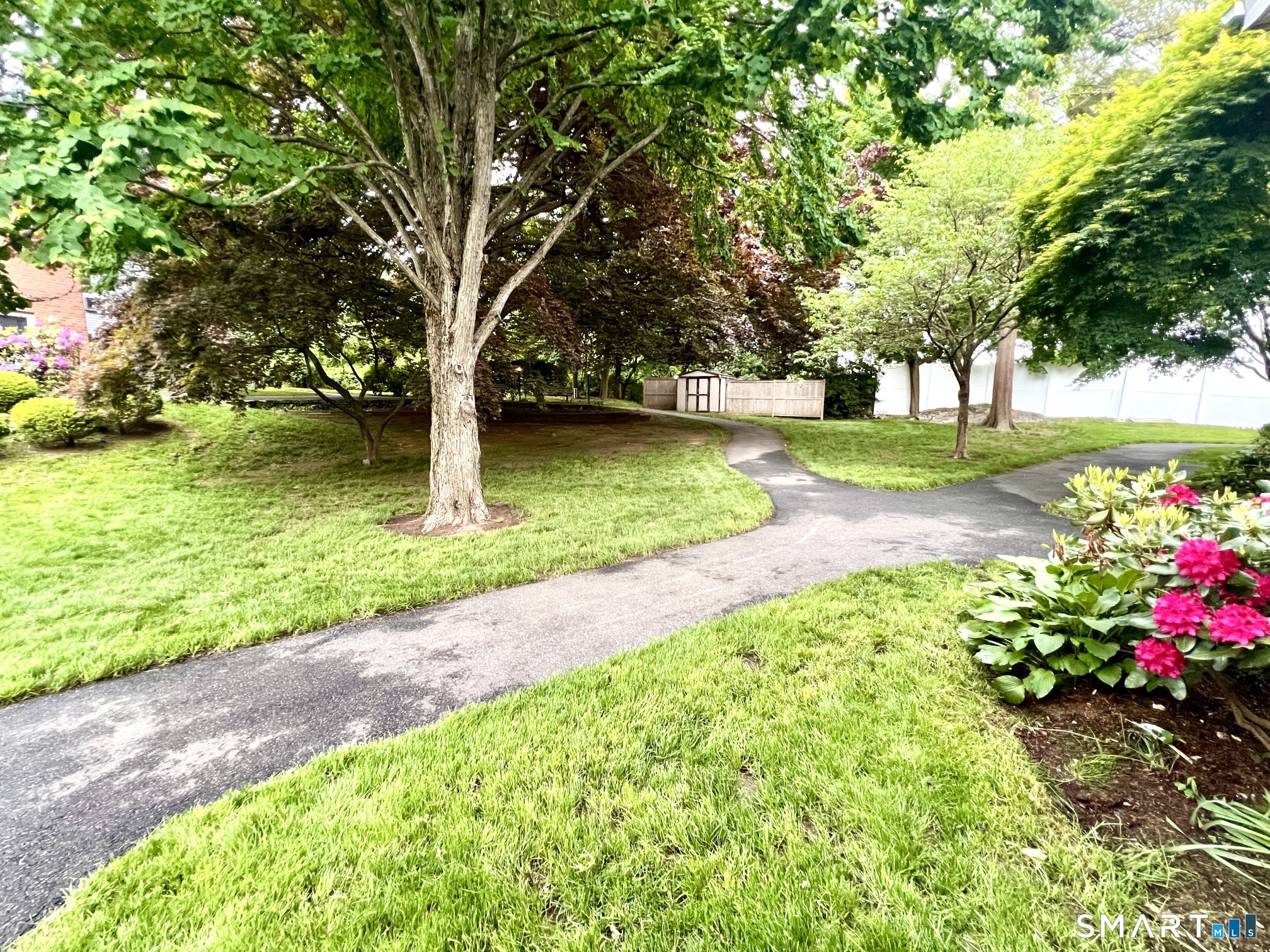 208 Flax Hill Road, Unit 32 Norwalk, CT 06854 - Photo 12 of 12 a view of a garden with a tree
