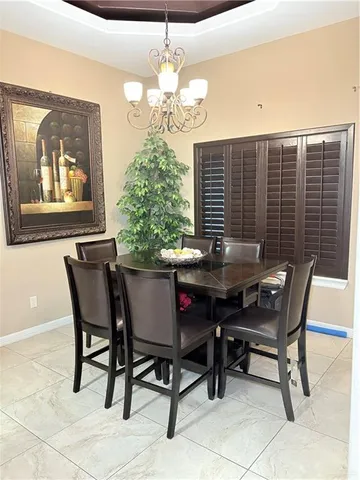 a view of a dining room with furniture and chandelier
